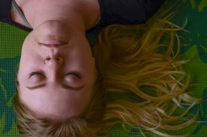 Calm looking woman lying on ground