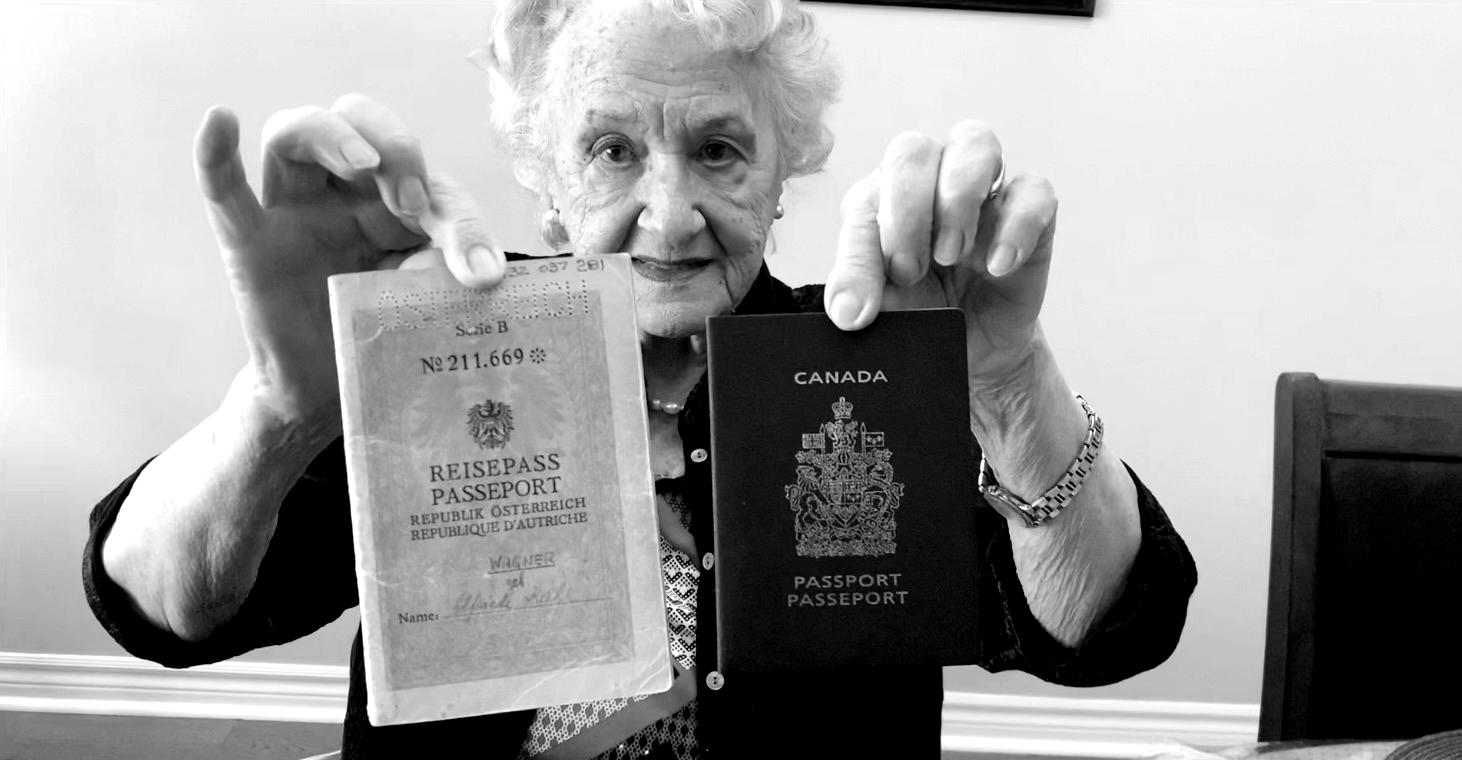 Black and white photo of an elderly lady holding up a Canadian and Austrian passport