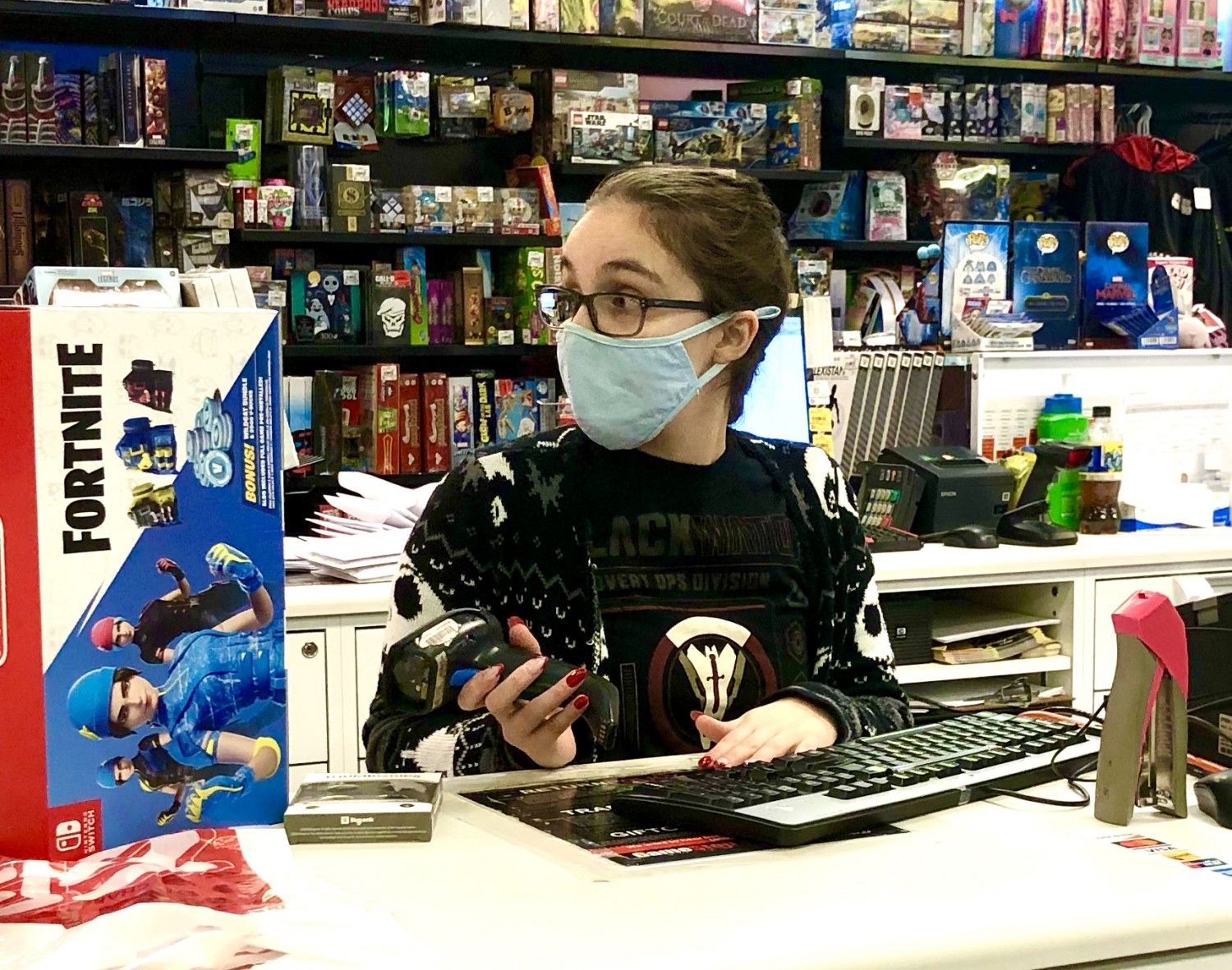 Samantha Patel working at EB Games following COVID-19 policies